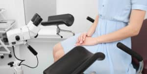 Woman in blue dress sitting and waiting for her gynecological check-up