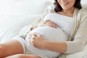 A pregnant woman holding her belly after creating a birth plan