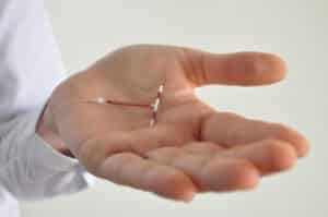 A woman holding a copper IUD in Houston, TX