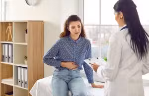 A cropped shot of a woman with pelvic pain in Houston holding her stomach Endometriosis vs. PMOS/PMOS/PCOS: What Are the Differences?