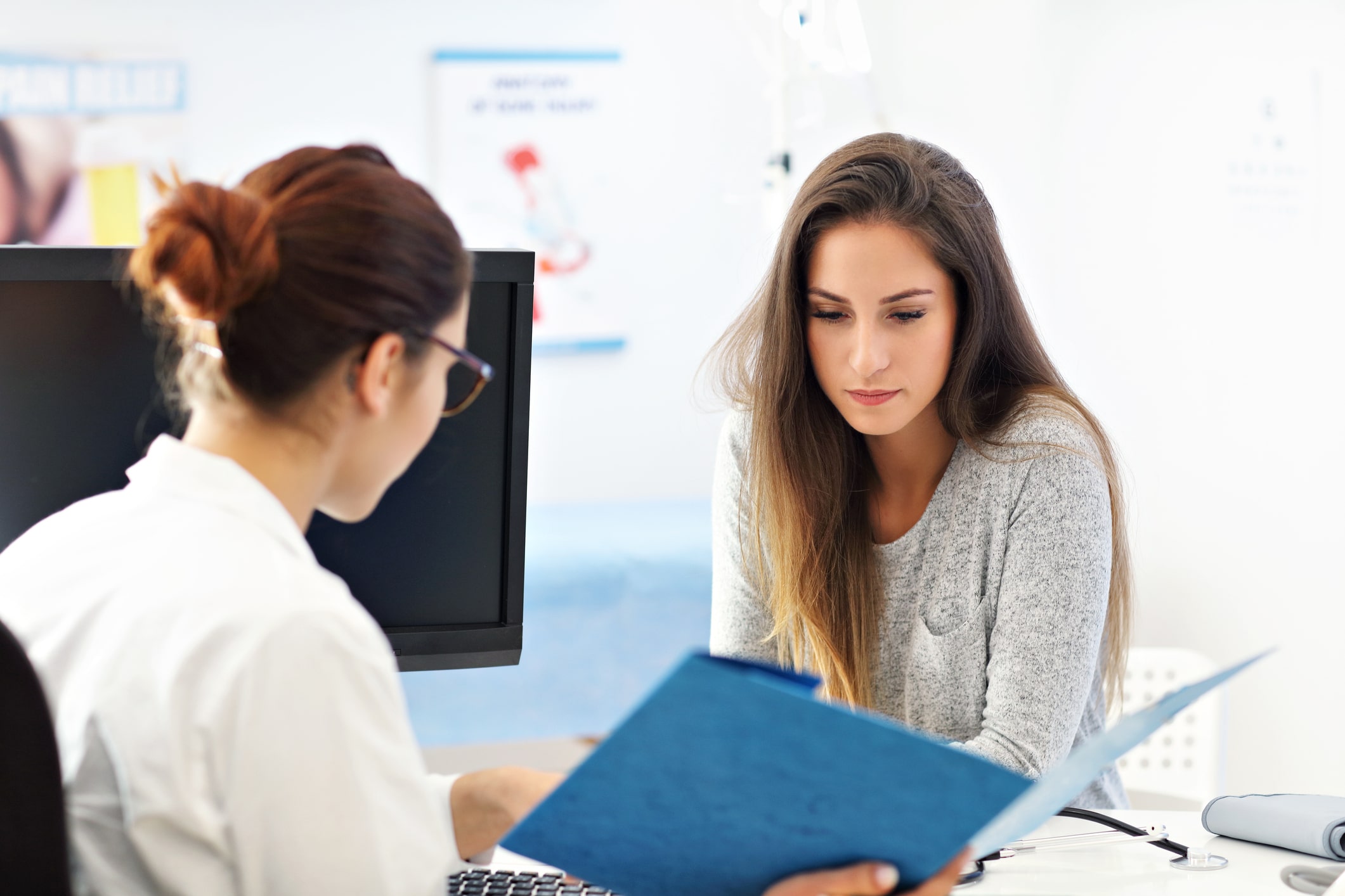 Adult woman having a visit at female doctor's office HPV Specialist Houston TX