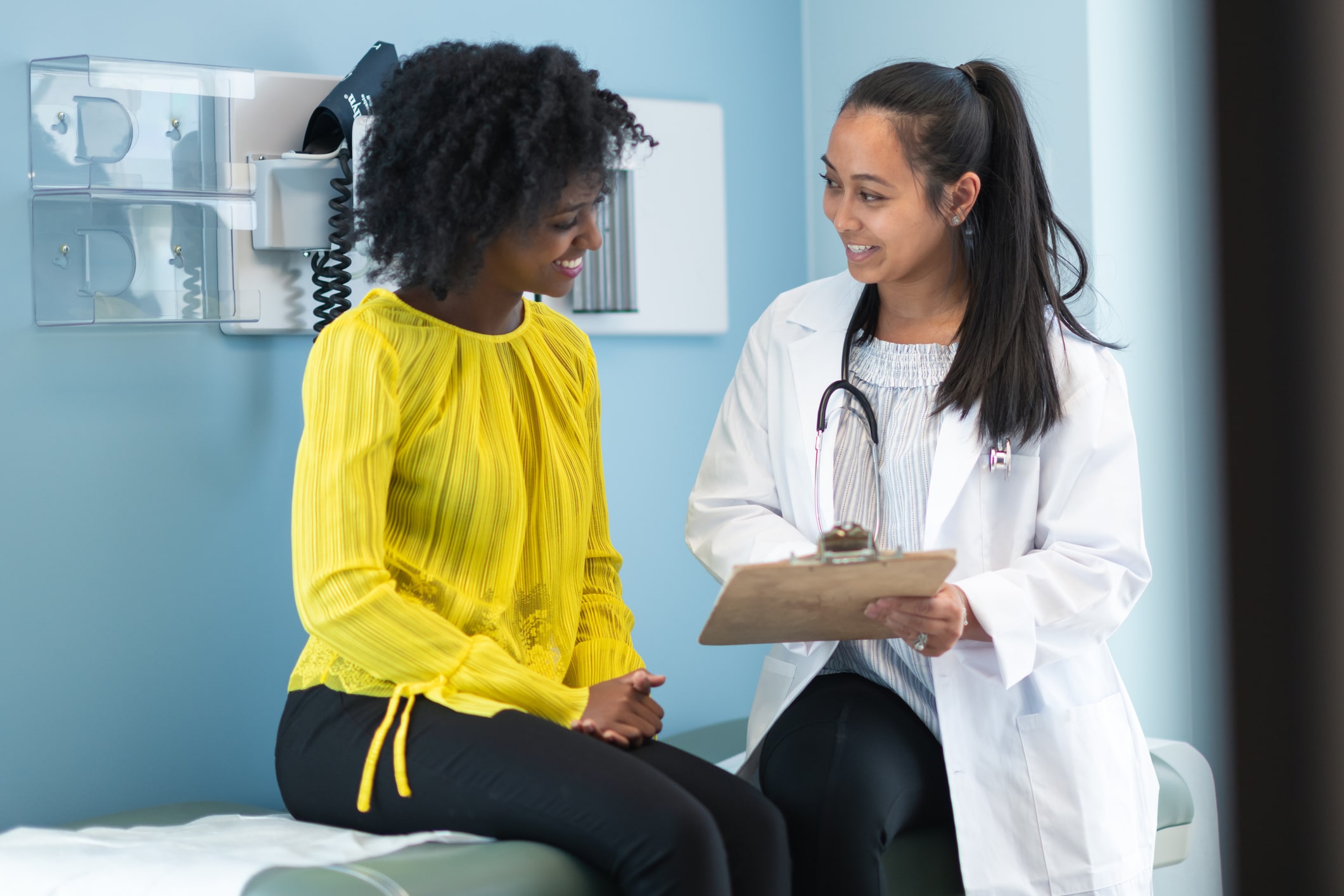 Ethnic woman in medical consultation with female doctor Colposcopy Houston TX