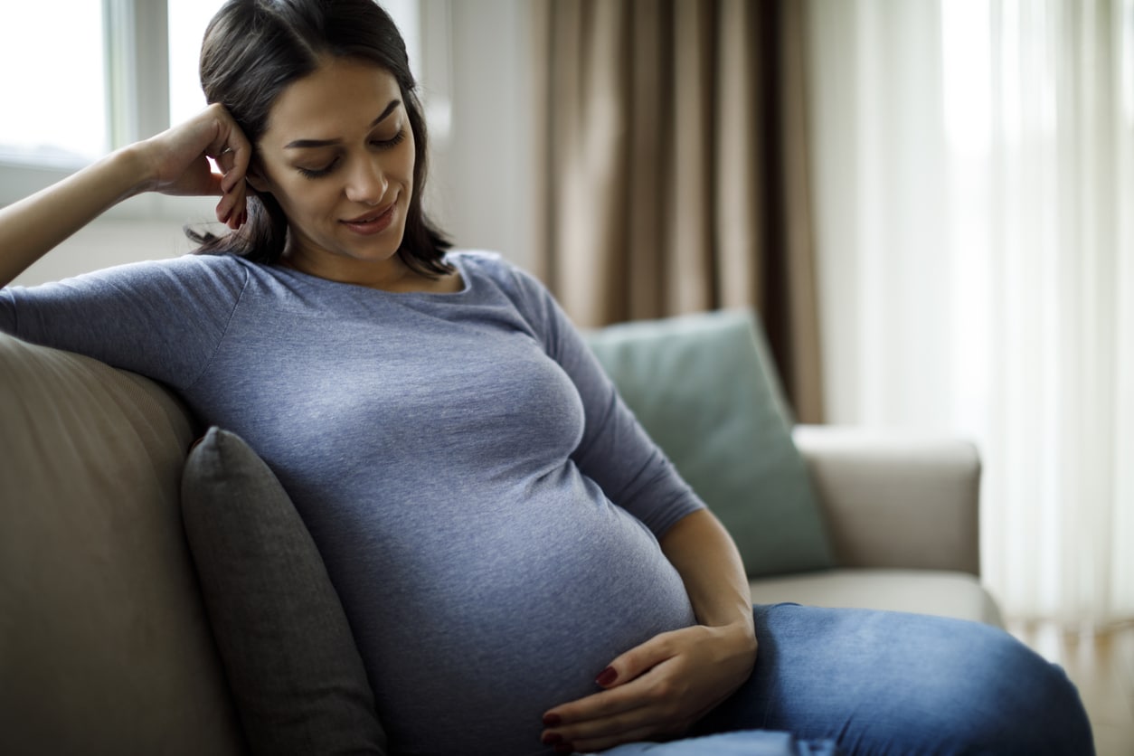 Portrait of young happy pregnant woman Pregnancy Services Houston TX