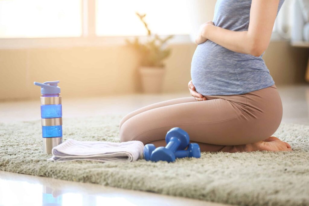 Beautiful,Pregnant,Woman,During,Training,At,Home A cropped shot of a pregnant woman kneeling on the floor