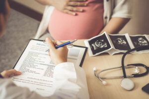 Cropped shot of a woman's stomach during a prenatal visit